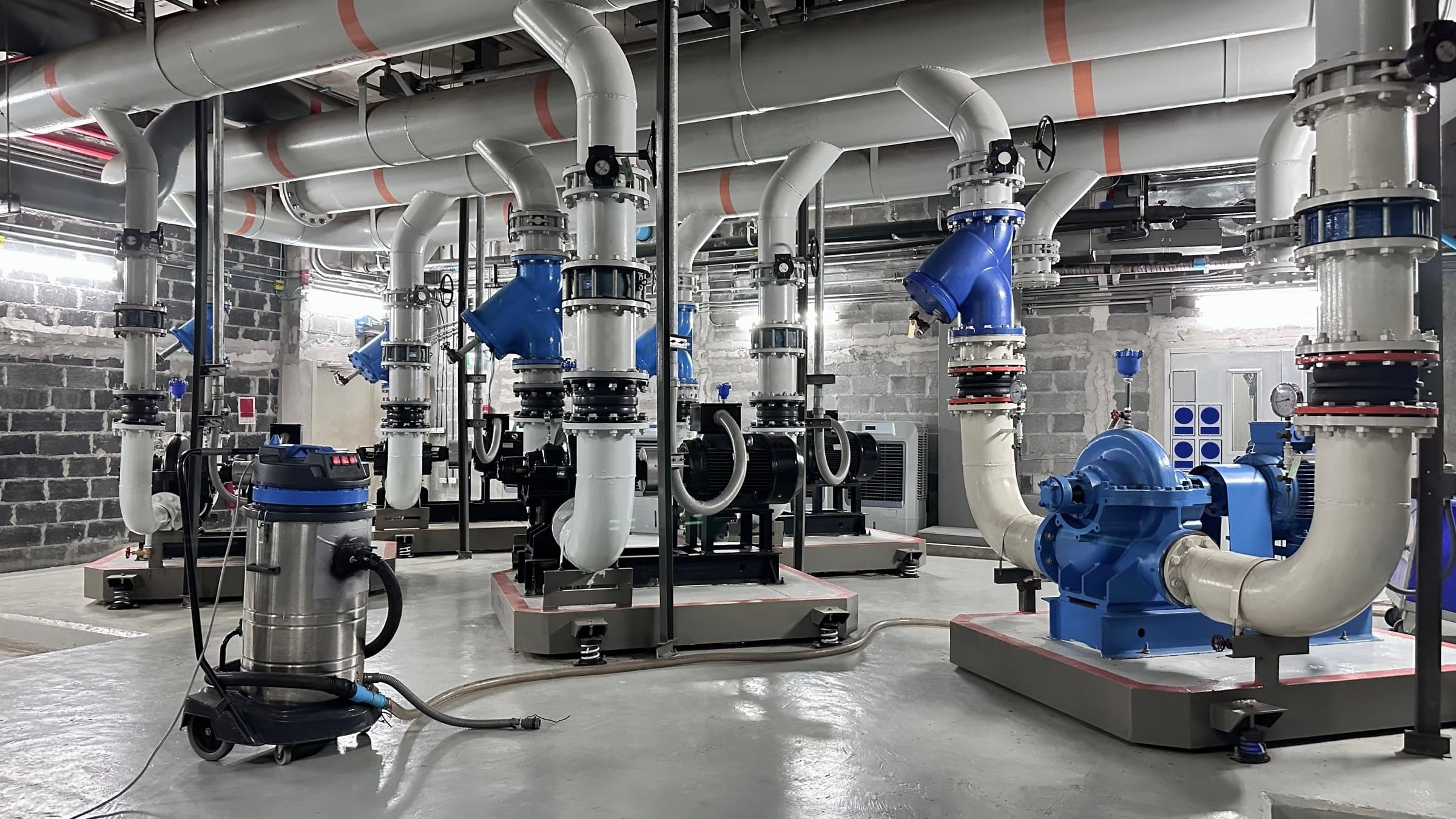 Industrial pump room with large process piping